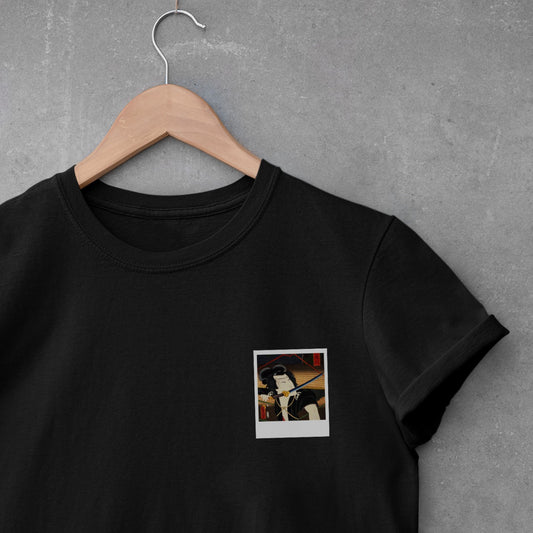 polaroid of Japanese man with sword in mouth on black t-shirt. 