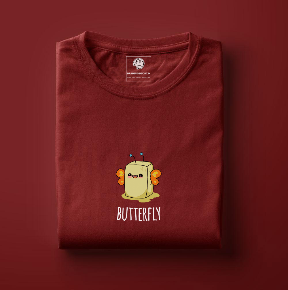 butter cube with orange wings becomes butterfly on maroon t-shirt hanging on wired fence